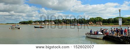 FELIXSTOWE, SUFFOLK, ENGLAND - AUGUST 29, 2016: A Panorama of to many people trying to board the ferry to cross the river Deben at Fekixstowe Ferry.