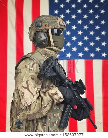 Us Soldier With Machine Gun In Hands And American Flag On Background