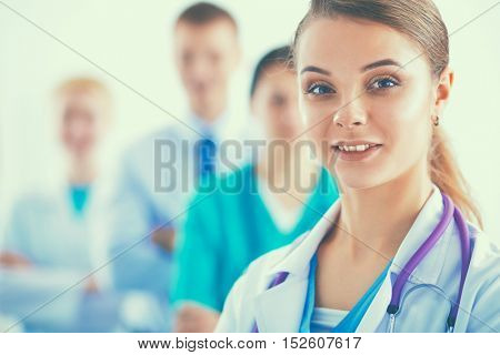 Group of doctors at hospital, focused at female physician.