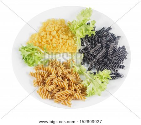 Gluten-free quinoa shells black beans rotini and chickpea rotini on a plate with leafy greens