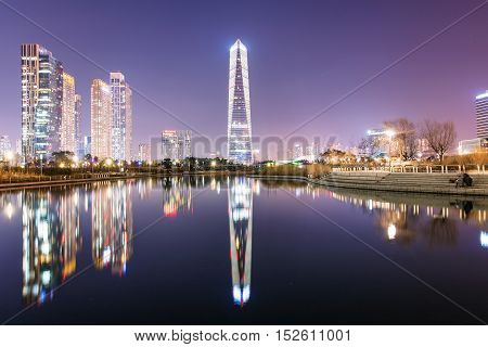 INCHEON REPUBLIC OF KOREA - FEBURARY 10 2016: Songdo financial district's Central park at night time with hotel buildings on Feburary 10 2016 in Incheon