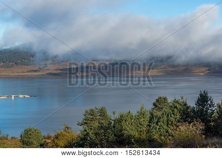 Amazing view of Low clouds over water of Batak Reservoir, Pazardzhik Region, Bulgaria