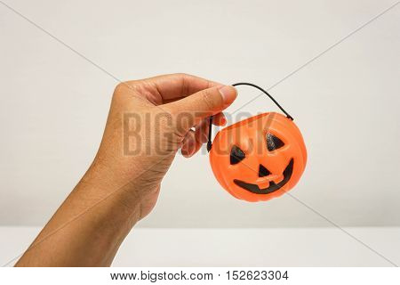 isolated close up woman hold orange Jack-O-Lantern bucket