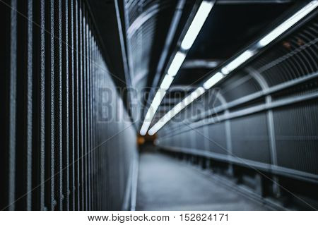 night time shot of long well lit bridge in out of focus perspective