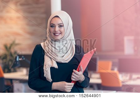 Arabian Business Woman Holding A Folder In Modern Startup Office