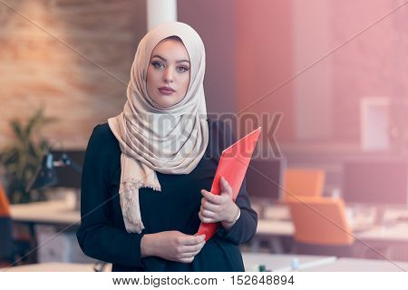 Arabian Business Woman Holding A Folder In Modern Startup Office