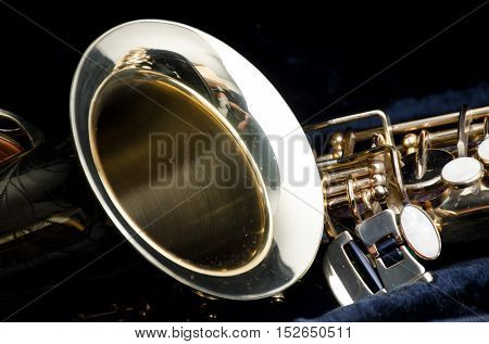 Saxophone alto jazz music instrument close up some light and shadow isolated on black