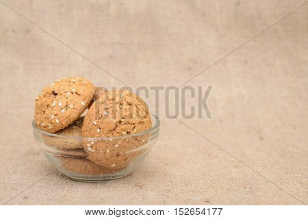 Cookies in the transparent plate with brawn background