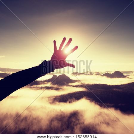 Man Hand Touch Sun. Misty Daybreak In A Beautiful Hills. Hilly Landscape In Fog