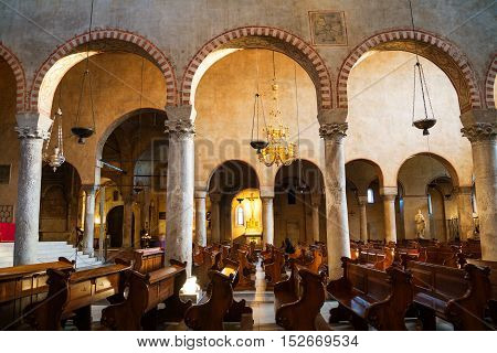TRIESTE ITALY - MARCH 1 2016: Inside Roman Catholic Cathedral dedicated to Saint Justus. Popular landmark. Arches with rows and people