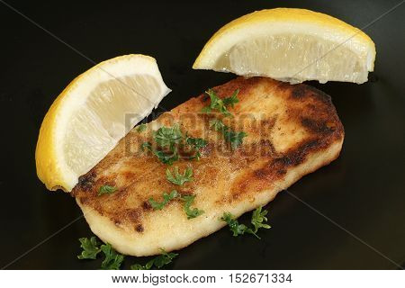 saganaki greek halloumi cheese appetiser with lemon wedges