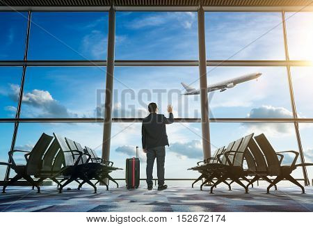 young businessman waving good bye at airport