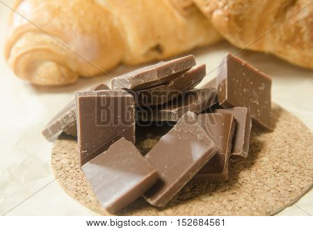 Chocolate on the background baked croissants on a stand