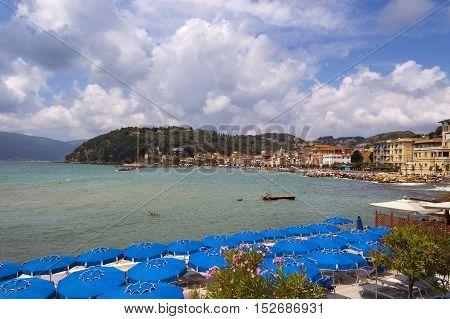 The village of San Terenzo (St. Terenzo) with the beach crowded with sunbathers. Lerici in the Gulf of La Spezia Liguria Italy