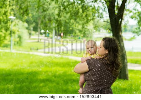 young woman and her cute baby girl outdoor