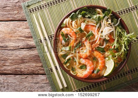 Malaysian Laksa Soup With Shrimps, Noodles And Herbs Close Up In A Bowl. Horizontal Top View