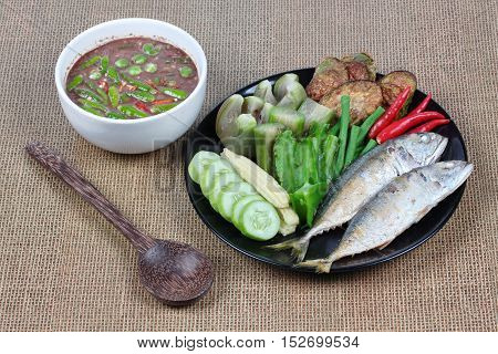 Thai local popular food as spicy shrimp paste dip (Nam Prik Kapi in Thai) iserved with side dish as deep fired mackarels,boiled long-eggplant,lentils,winged bean ,red hot chili pepper and cucumber.