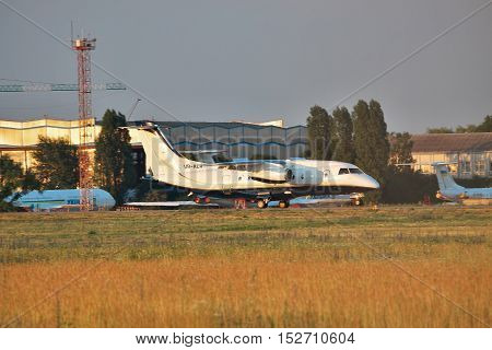 Borispol Ukraine - June 9 2011: Dornier Do-328-300 (Do-328JET) regional passenger jet plane is landing on the runway on sunset