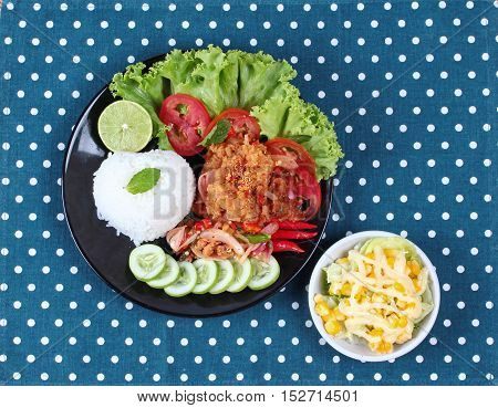 Jasmine rice with spicy fried chicken salad (Khao Yum Kai Zap in Thai) served mixed vegetables salad.