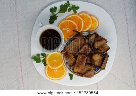 beautiful light on calories breakfast cup of black tea,juicy orange and dry rye crackers