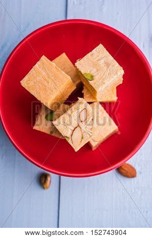 Close-up of soan papdi or son papdi with almonds and pistachio or pista