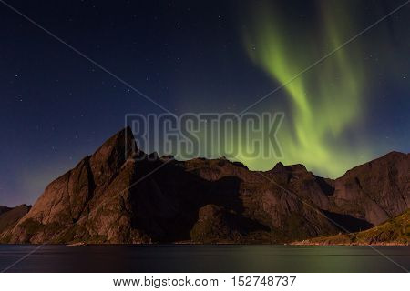 Northern lights over Olstind mountain Lofoten Norway