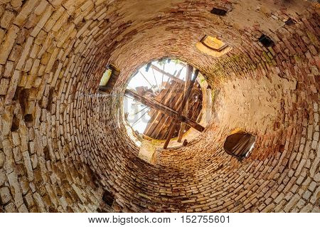 The Inside Bottom View Of Destroyed Abandoned Brick Through Tower In Evacuated Zone After Chernobyl Catastrophe. Consequences Of The Nuclear Contamination