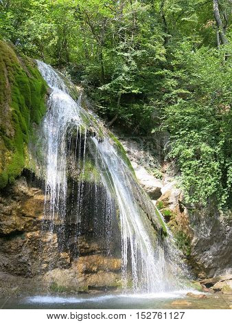 waterfall on a mountain river in the forest