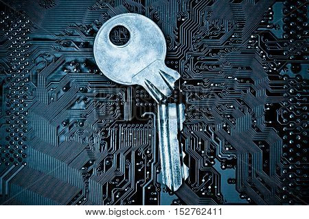 A broken key on computer circuitboard background / computer security breach concept