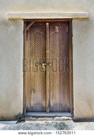 Wooden door of a traditional Omani house in Wakan Village