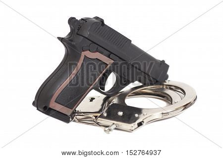 Gun and handcuffs isolated on white background