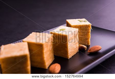 Close-up of soan papdi or son papdi with almonds and pistachio or pista