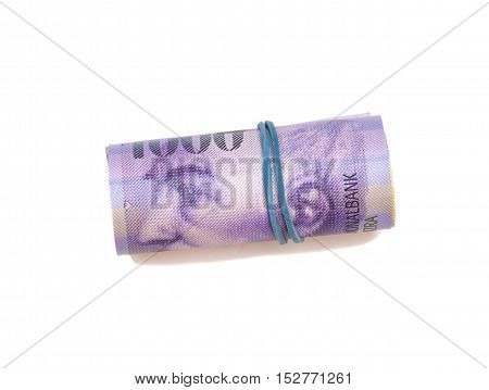 Swiss thousand francs in a roll on white background
