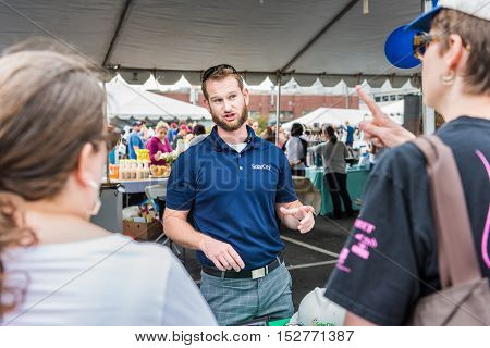 Washington DC, USA - September 24, 2016: SolarCity salesman representative talking to people
