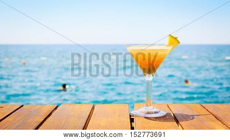 Concept Of Tropical Vacation. Exotic Cocktail On The Pier. Luxury Holiday Background. Orange Cocktai