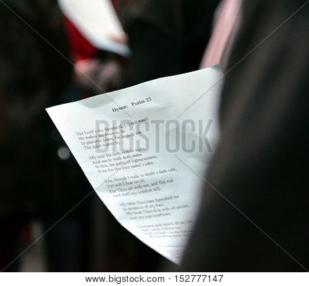 Sydney Australia - April 25 2013. Man helds the "Hymn: Psalm 23 The Lord's my shepherd" during ANZAC Day Sunset Service at Martin Place.