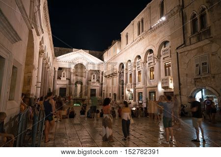 Split, Croatia - July 20, 2016: a lot of people at the peristyle in the Diocletian Palace at night
