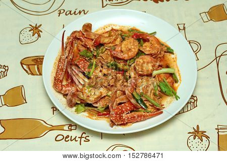 Stir-fried crab and shrimp in curry power is top-ten of popular Thai food as seafood to fried with  fresh milk ,grill curry ,egg ,oyster oil and yellow curry powder.
