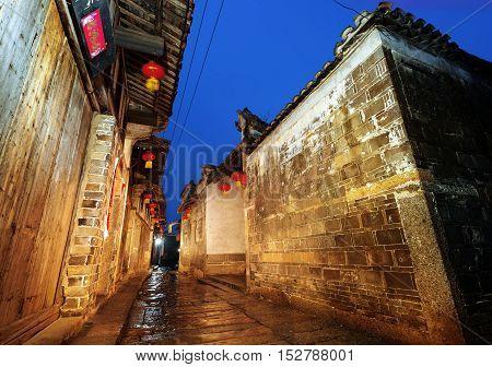 Rain China town thousands of years alleys at night.