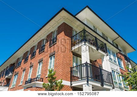The top of brand new apartment building on blue sky background in British Columbia Canada