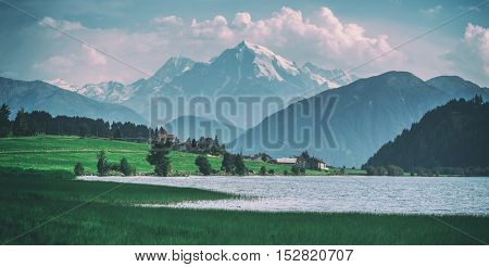 Beautiful view of the lake Muta (Haidersee) and Ortler peak, located near the village St. Valentin, Alps, Italy, Europe, toned like Instagram filter