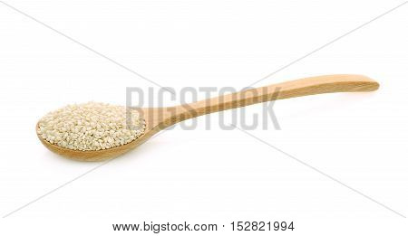 white sesame seeds in wooden spoon isolated on a white