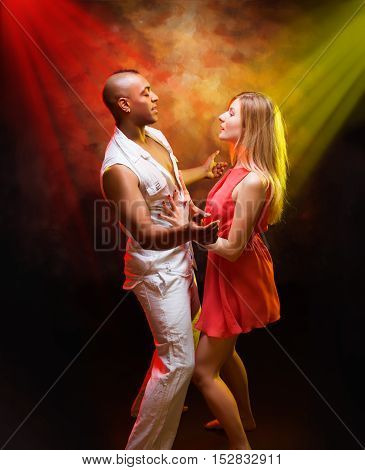 Young and sexy couple dances Caribbean Salsa