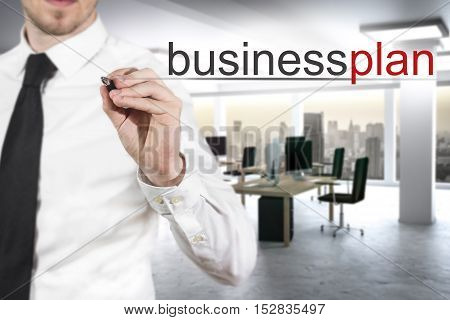 businessman in modern office writing businessplan in the air
