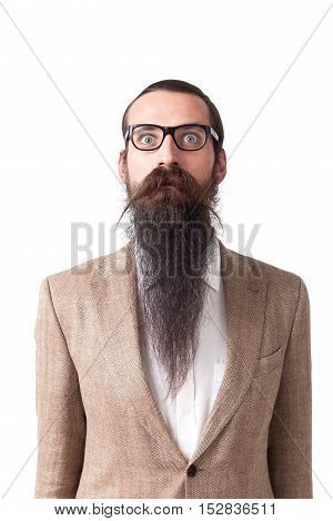 Baffled man wearing glasses and long beard is standing against white background. Concept of eccentric person.