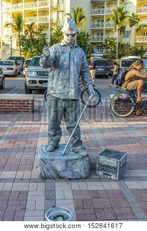 Key West, Florida, United States - April 13, 2012: a street artist performs during the Sunset Celebration at Mallory Square. Show of street artists is one of most popular attractions of Key West.