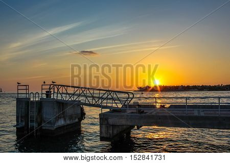 Sunset at Mallory Square in Key West, Florida. The Sunset Celebration at Mallory Square with the show of street artists is one of most popular attractions of Key West.