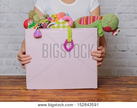 Woman with box of toys ready for donation