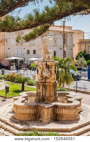 NOTO ITALY - SEPTEMBER 14 2015: Hercules fountain in Noto famed for its Baroque architecture. UNESCO World Heritage Site in Noto Sicily Italy.