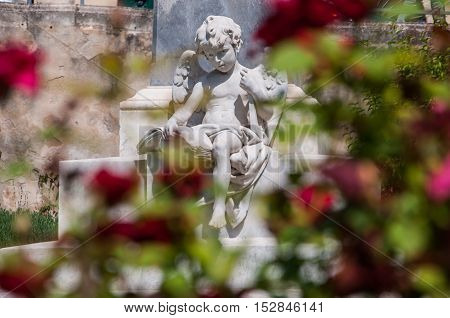 NOTO ITALY - SEPTEMBER 14 2015: Sculpture of an angel on a street in the old city center in Noto Sicily Italy.